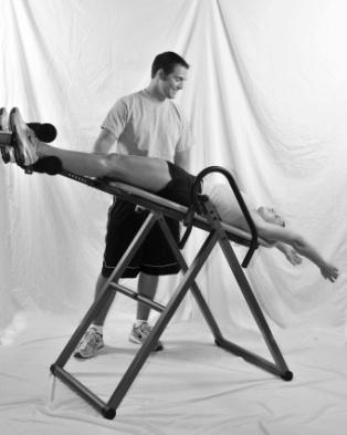 Then, slowly raise your other arm and move it up over your head. The inversion table will safely invert to the set degree. Rest your arms over the head and relax.