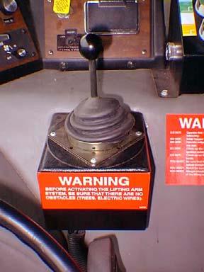 Figure 11. Single Joystick PACKER CONTROLS Three buttons located on the console control the different packer functions. Red Button The red button is an emergency feature.