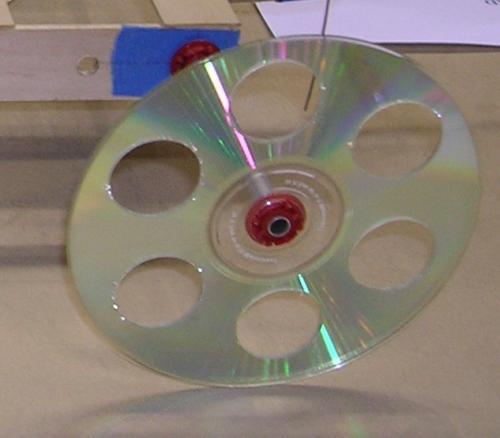 Wheels CD size can add mass requiring more energy Drilled holes reduce the mass, getting a better effect