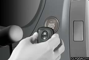 Touch the Lexus emblem side of the electronic key to the ENGINE START STOP switch.