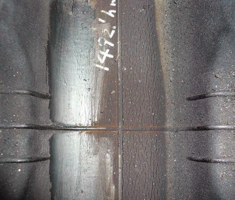 Around the base of the guide lug Check periodically to determine if cracks reach the steel cable Remove