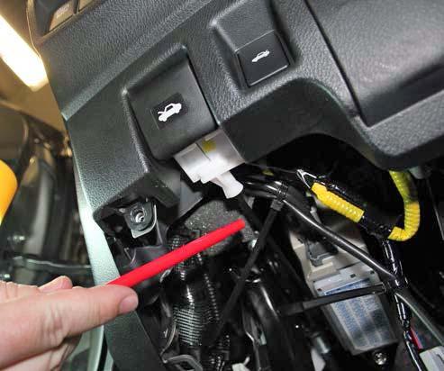 CAUTION: Make sure the wire is routed above the hood latch cable. Do not attach the wire to the hood latch cable. Fig.