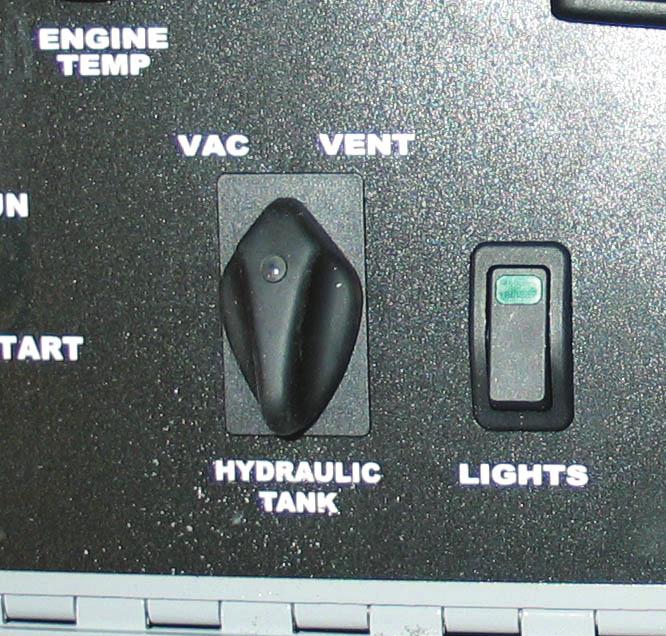 the hydraulic tank. This can be done by rotating and holding the Vent Switch in the clockwise position. The Vent Switch is located on the upper dash panel inside the cab. See Figure 3.