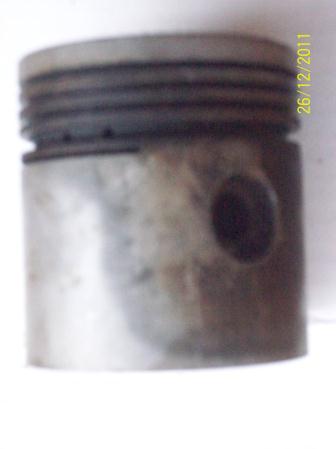v) Piston : It is a cylindrical part closed at one end and open at the other end, which maintain a close sliding fit in the engine cylinder. The piston is shown in Plate 2.5.