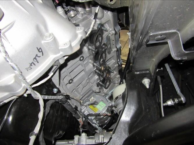 Once supported, remove four bolts (13mm head) securing the passenger side engine mount bracket to the engine and rubber isolator. (See Fig. 7) 8.