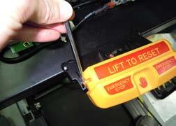 3) Remove the 2 screws holding the emergency stop key to the