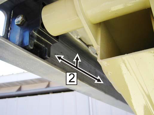 Apply a layer of grease along the inside and top of the upper slide channel (2) on both sides of the machine. Refer to Figure 6-3., Upper Slide Pad Channel. Figure 6-2.
