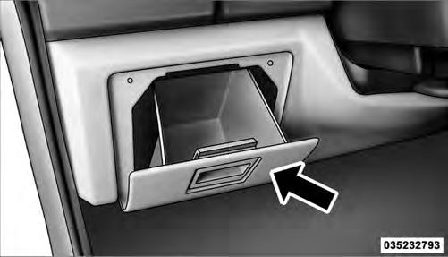 Pull outward on the latch to open the storage compartment.