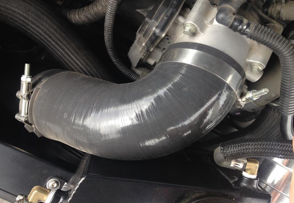 Slide the 3.5 90 degree coupler onto the end of the tube and connect it to the throttle body. 8. Find the surge system bag that comes in the kit.