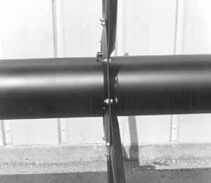 MOUNT REEL TO HEADER SUPPORT ARMS. NOTE: If header is not available, position new stands at left and right mounts and clamp reel securely. Remove supports under reel center tube.