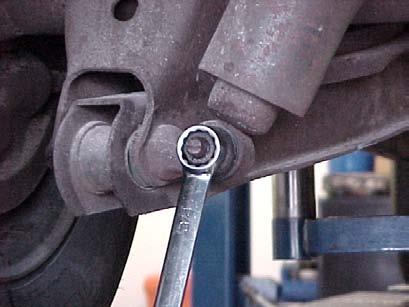 3) Unbolt the shock from the rear axle, and pull it clear of