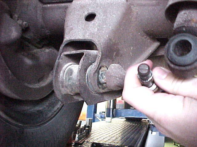 You may have to move the exhaust system to remove the bolt at