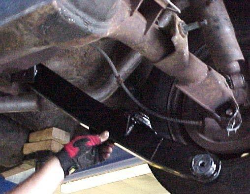 Apply a light coat of grease to the bushing contact areas on the frame and axle.