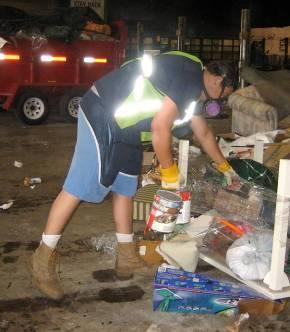 6: Ops II worker inspecting dumped material. Fig.