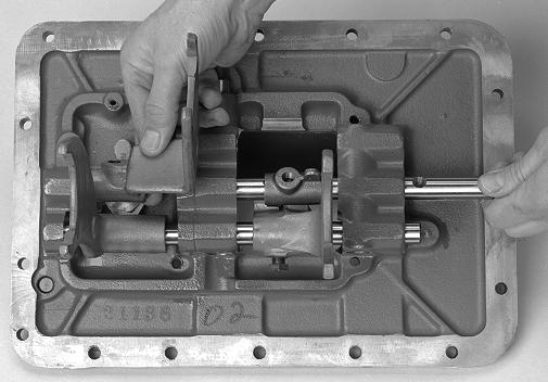 Transmission Overhaul Procedures - Bench Service 4. While removing the top Yoke Bar to the right, remove the two (2) Shift Blocks. 5. From the middle Yoke Bar, remove the Shift Yoke and Shift Block.