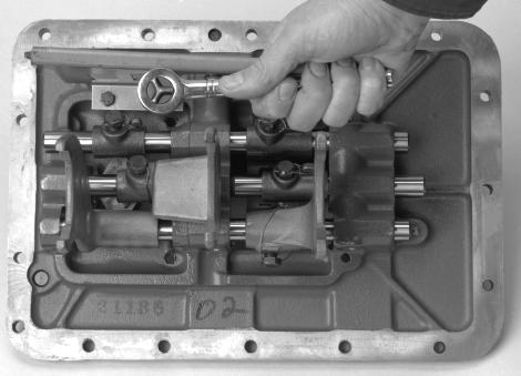Transmission Overhaul Procedures - Bench Service 15. Holding the top Bar notched end, start installation. As the Bar passes the Rear Boss, position the Shift Block. 16.