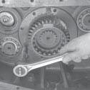 assembly rearward to move the auxiliary drive gear bearing from its bore. 4.