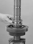 Insert two large Screwdrivers between the two gears. Apply slight downward pressure to spread the gears evenly.