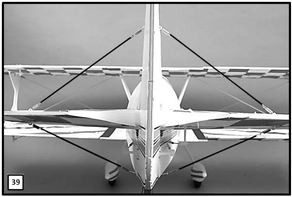 Repeat the process for the other side of the model. Attach rigging springs to each of the eyelets positioned on the vertical fin and tail-wheel bracket.