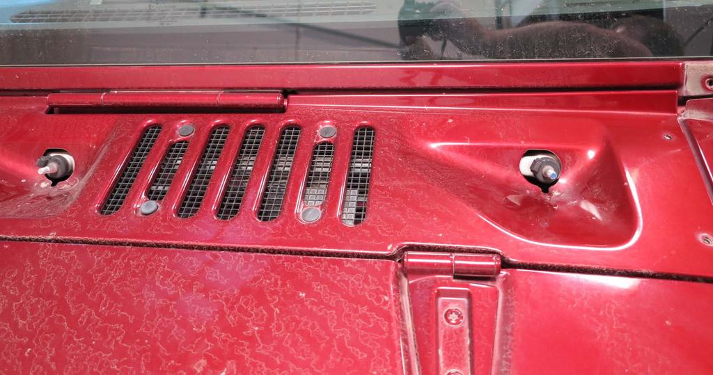 After the wipers are free, remove the 2 bolts on each side of
