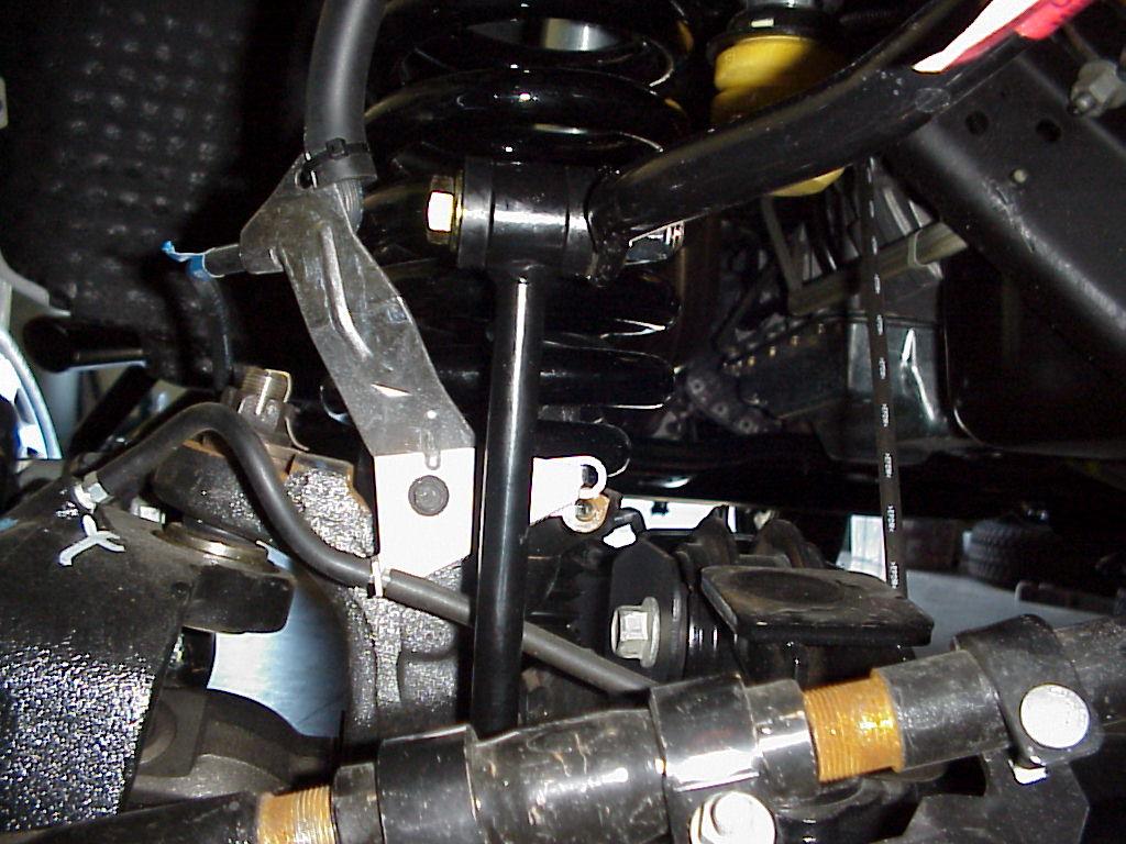The lower bracket goes behind the stock brake line bracket and rotates the bracket out toward the wheel and away from the longer sway bar link eyelet. 21. Jack up the axle 2-3 from droop.