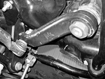 Figure 25 36. Attach brake line relocation brackets to the top side of the axle with the factory bolt and 5/16 self threading bolt into the original locating tab hole.