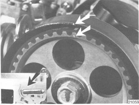 Remove the crankshaft pulley and vibration damper. Remove the belt cover and make a mark on the edge opposite the mark on the camshaft gear. Undo the belt tensioner. Remove the belt. Begin at the tensioner.
