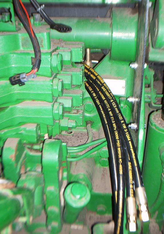 Routing the steer in and steer out hoses Valve bracket AutoSteer hoses before connecting to the valve The four AutoSteer steering hoses (steer in and steer out) must be