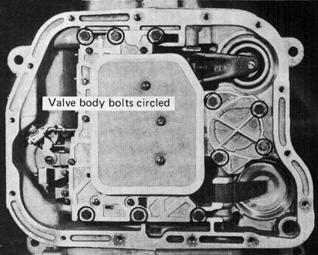 STEP 2. The valve body will now be exposed. (See Fig. 1.) It is held in place by ten, 1/4-20 bolts. Before the valve body can be removed, you must disconnect shift and throttle linkage. (See Fig. 2.) Throttle linkage is located on the left (driver) side of the case, just above the valve body.