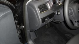 side panel of the dashboard on the driver's side.