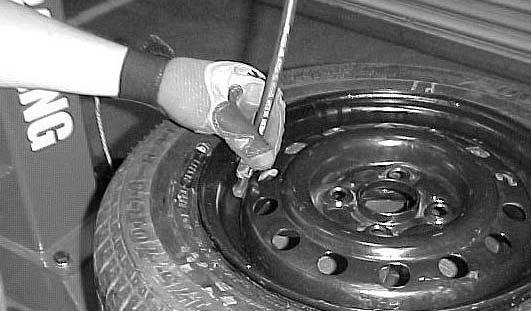 An exploding tire, rim or other wheel component can cause death to operator and/or bystander. REMAIN CLEAR AT ALL TIMES. 3. Pull the trigger on the inflation hose to begin inflating the tire.