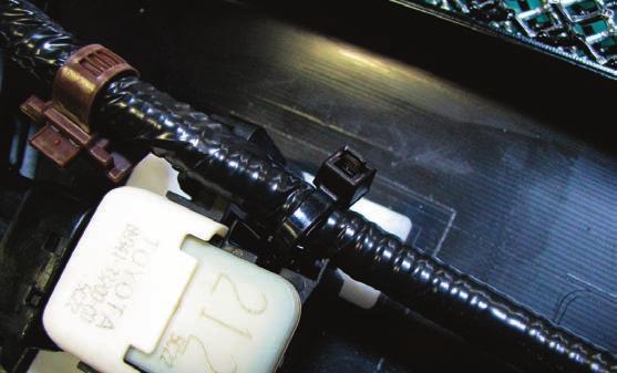 56. Install the supplied black cable ties to secure the factory wire harness and keep it from