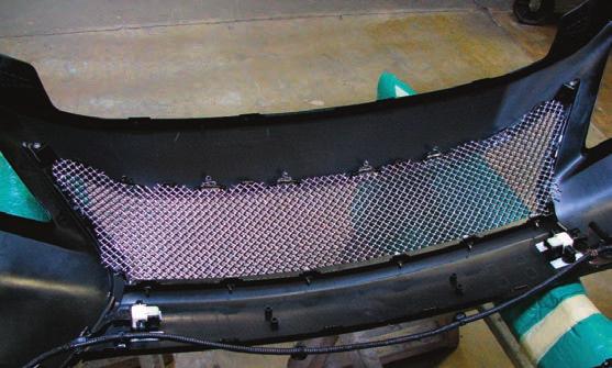 For Stacked grilles: Turn the bumper cover face down, align the black mesh first between the retainer and the