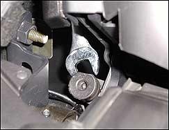 3. Loosen the adjustment lock nut. Reach in from the soft-top storage area.