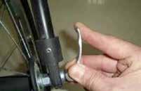 After aligning the front wheel in the fork slots, slide the wheel all the way into the front fork (Fig 33).