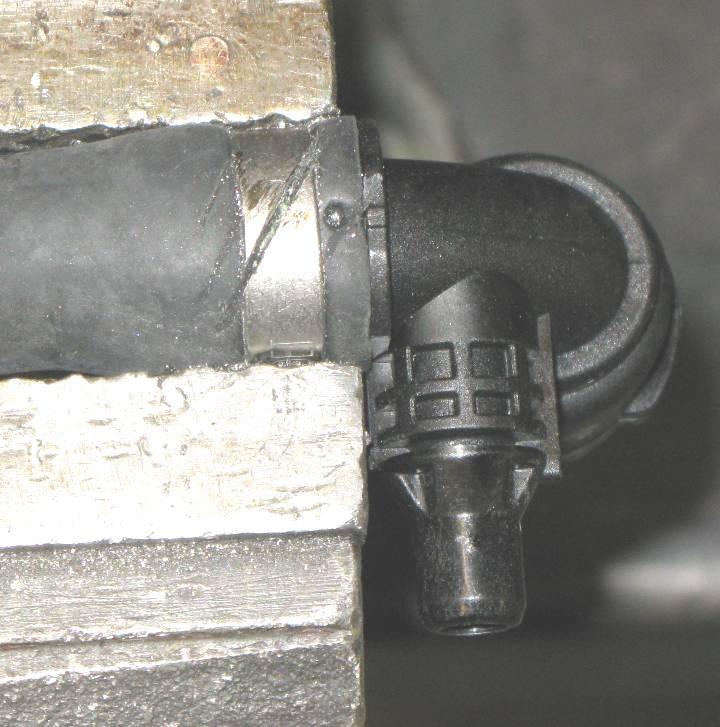 Clamp coolant hose lightly in a vise and cut the clamp