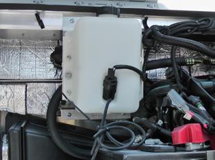 Disconnect the wiper motor harness to the jumper harness. NOTE: Removal of the washer bottle assembly is only necessary on the Ford E-Series chassis.