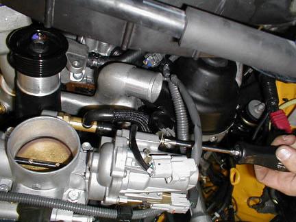 Locate the /C compressor on the driver'sside of the engine and remove both the OE