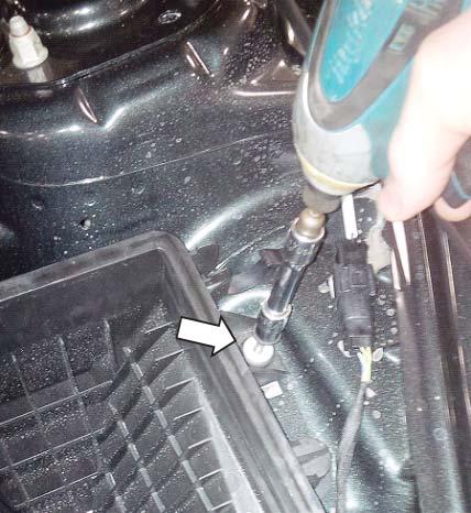 Using the 10 mm socket, remove the bolt holding the
