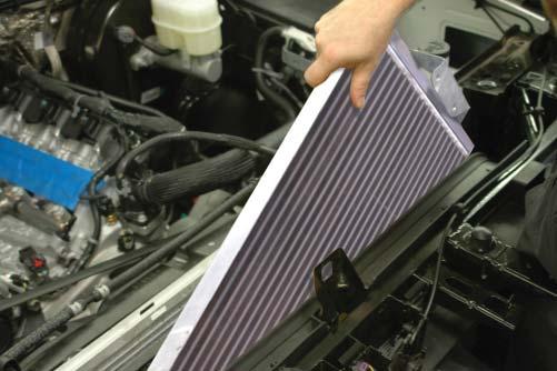 57. Slide the provided low temperature radiator (LTR) assembly into the space created by pushing the radiator assembly