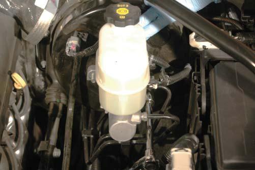 65. Remove the two nuts holding the master cylinder to the brake booster canister using a 15mm socket. 66.