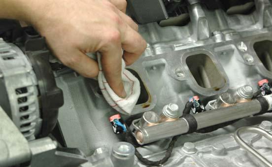 Remove the tape or rags covering the intake ports on the heads.