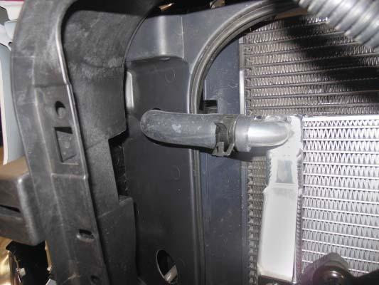 upper hole made in the plastic near the radiator as shown with the yellow arrow. 112.