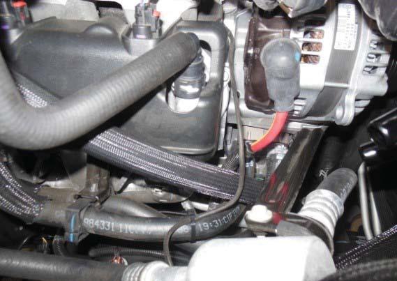 If you choose to connect the sensor post install, it may be helpful to swing the alternator out of the way, as shown to the right.