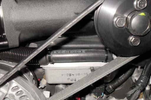 Route the hose under the supercharger inlet toward the right hand side of the vehicle.
