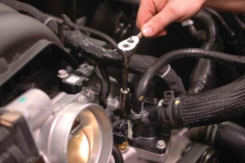 side valve cover, depress the tab and pull the hose free from the vehicle.