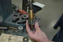 Install new angular contact bearings. Use a 1/2 inch I.D. tube a as a driver (and to protect the tip of the swivel shaft). Use a 7/8 inch I.D. tube to apply the base to the inner race of the angular contact bearings.