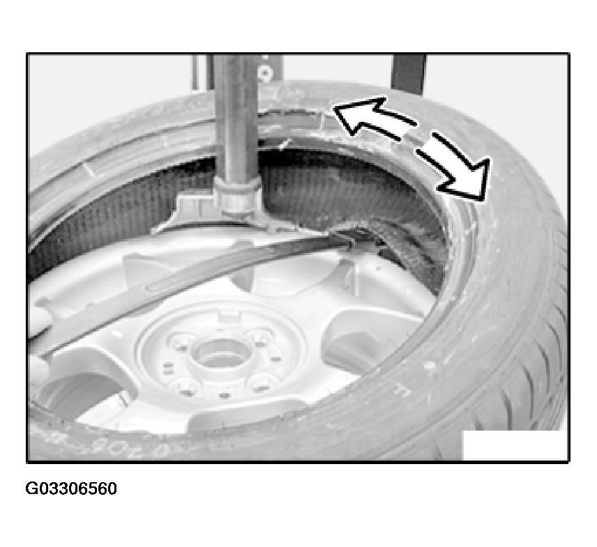 Fig. 23: Levering Tire Bead Off Rim Release lock and tilt or