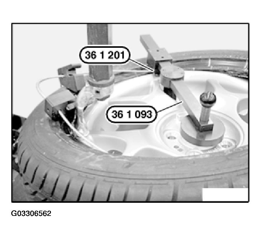 Arrange special tool 36 1 201 on rim flange as illustrated. 2006 MINI Cooper Make sure the tire beading is fitted correctly on the mounting head.