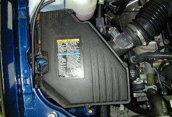 Remove the air box by removing the two bolts and the nut securing it. Lift air box out of vehicle. d.